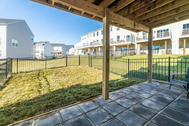 a view of backyard with wooden fence