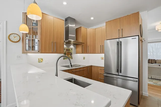 a kitchen with stainless steel appliances a refrigerator and a sink