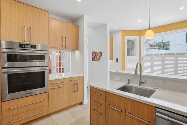 a kitchen with cabinets appliances and a sink