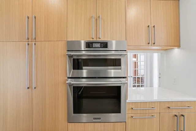 a stove top oven sitting inside of a kitchen