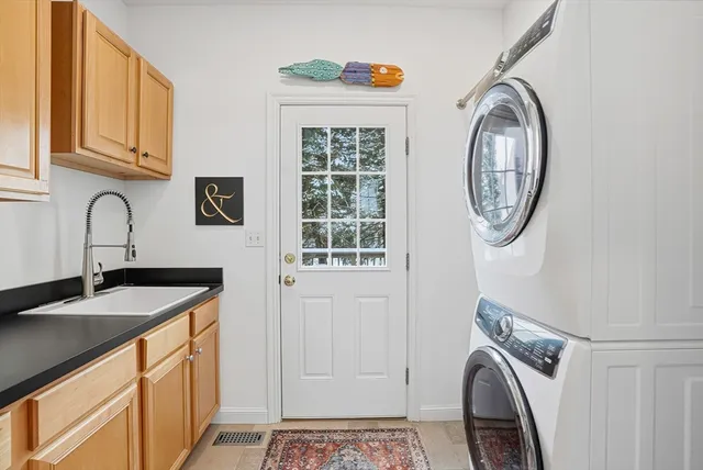 a utility room with a sink a washer and dryer