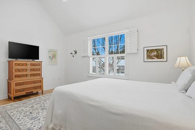 a bedroom with a bed and a television