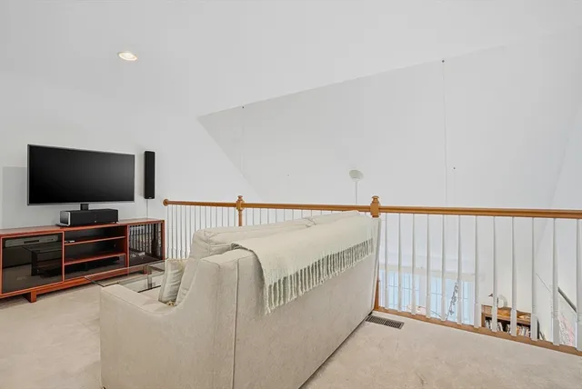 a living room with furniture and painting on the wall