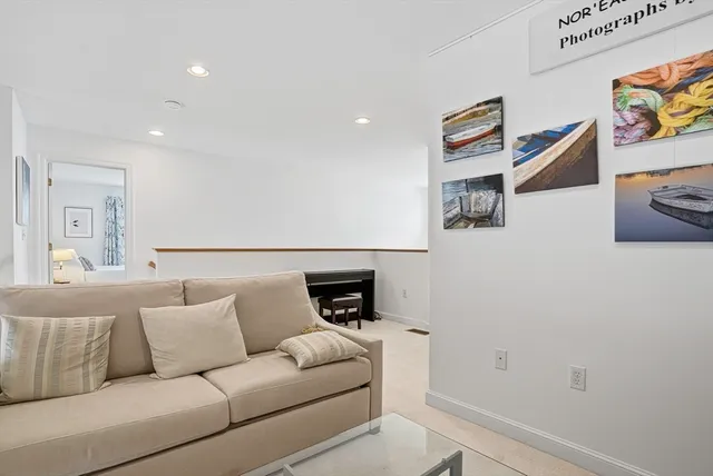 a large bed sitting in a bedroom next to a window and a dresser