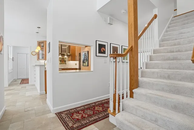 a view of staircase with white walls and a window