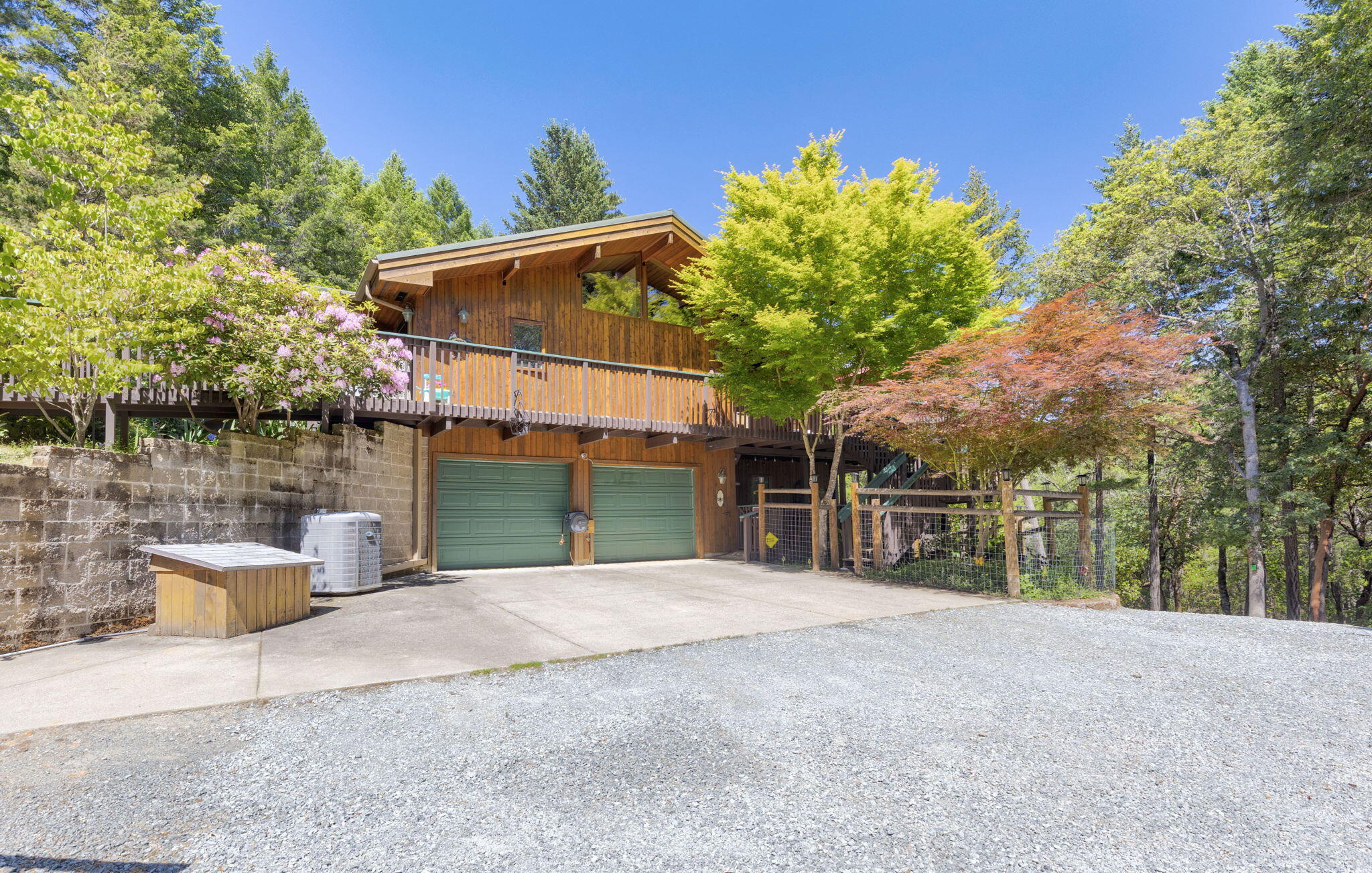 856 Greentree Loop Grants Pass, OR 97527 - Photo 43 of 62 a front view of a house with porch and garden