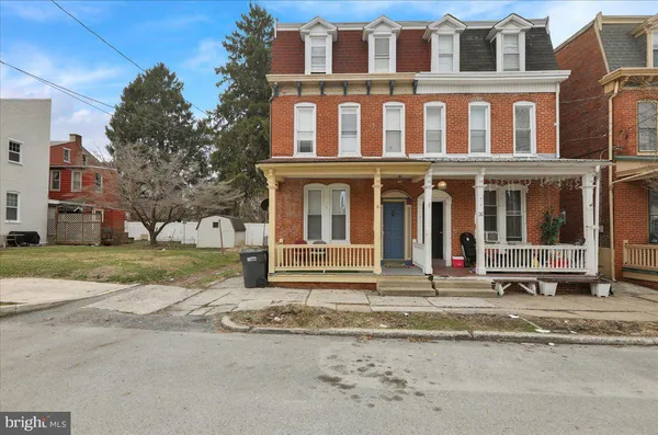 a view of a building with a yard