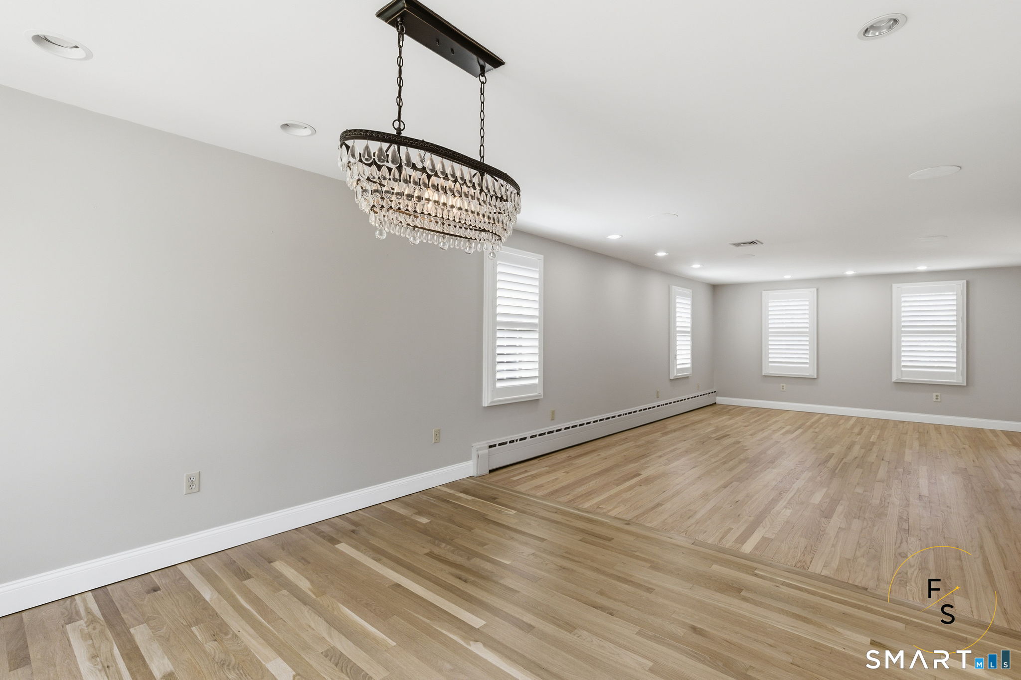 508 Highland Street Wethersfield, CT 06109 - Photo 15 of 40 a view of an empty room with window and wooden floor