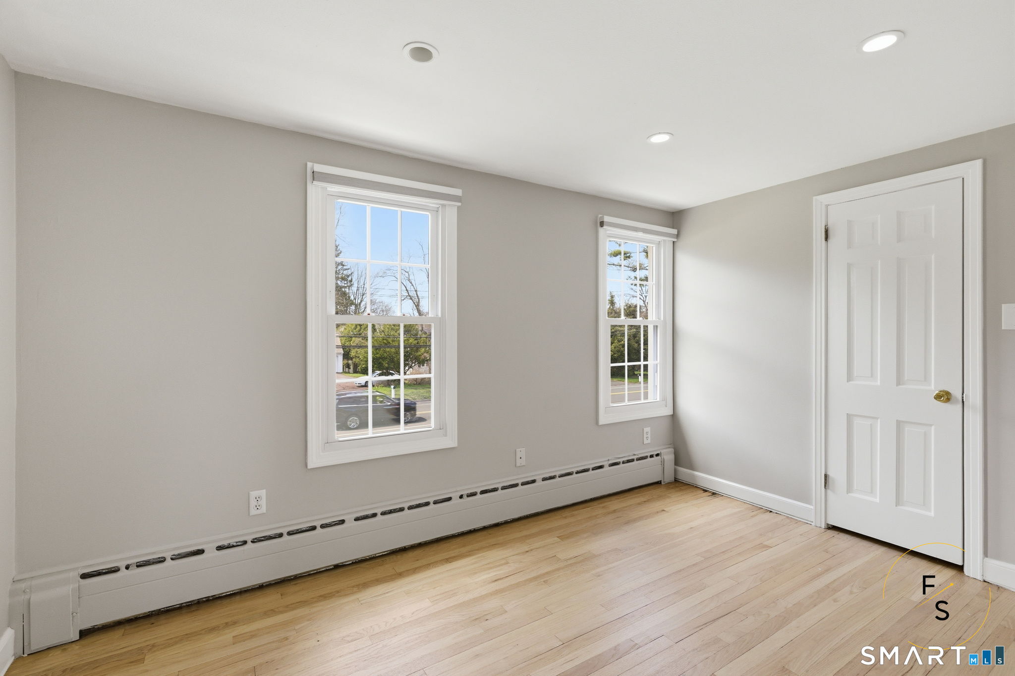 508 Highland Street Wethersfield, CT 06109 - Photo 26 of 40 an empty room with wooden floor and windows