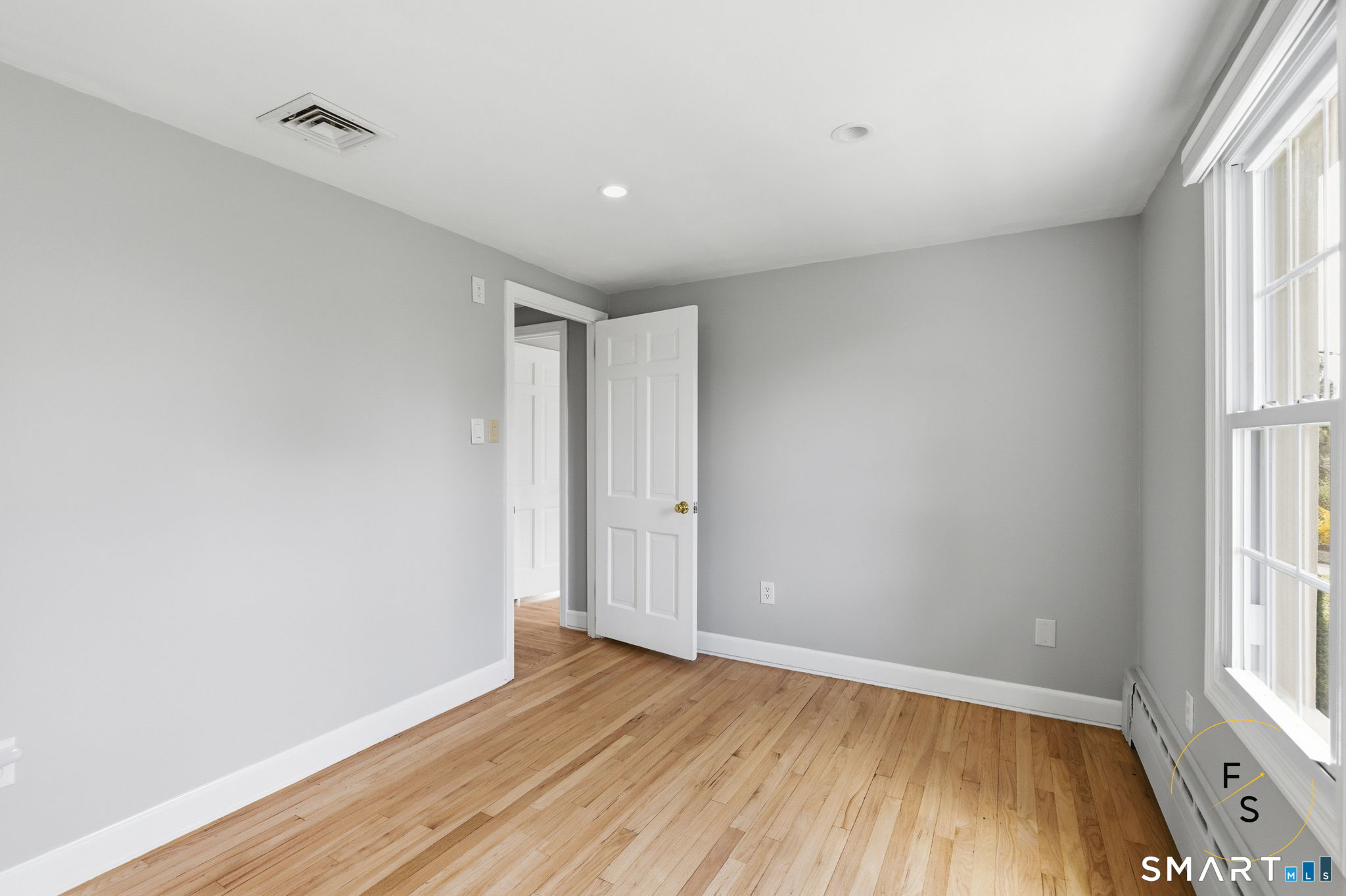 508 Highland Street Wethersfield, CT 06109 - Photo 27 of 40 an empty room with wooden floor and windows