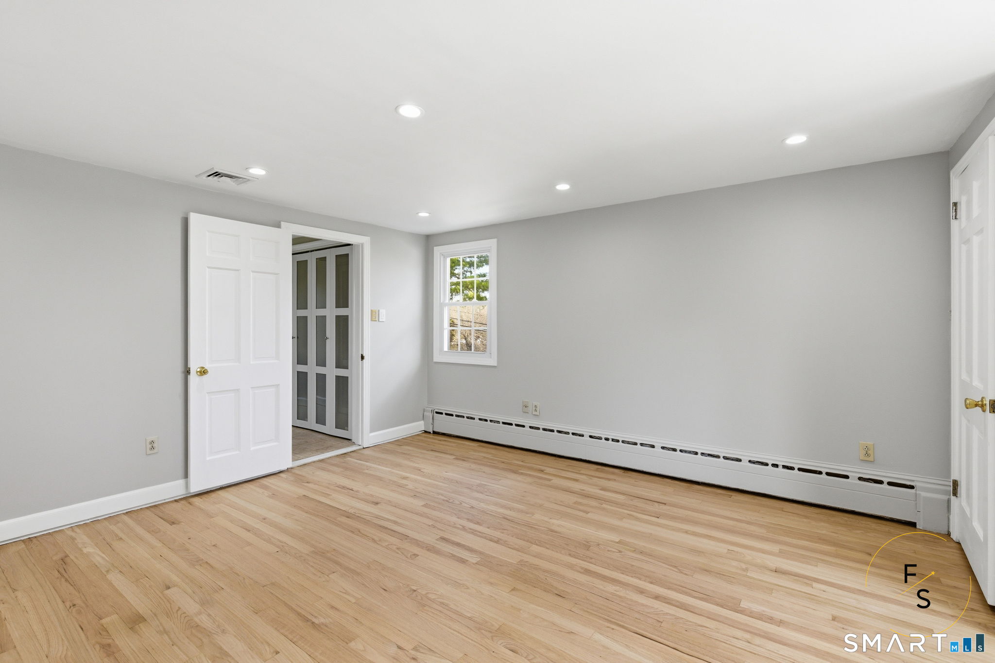 508 Highland Street Wethersfield, CT 06109 - Photo 34 of 40 a view of an empty room with wooden floor and a window