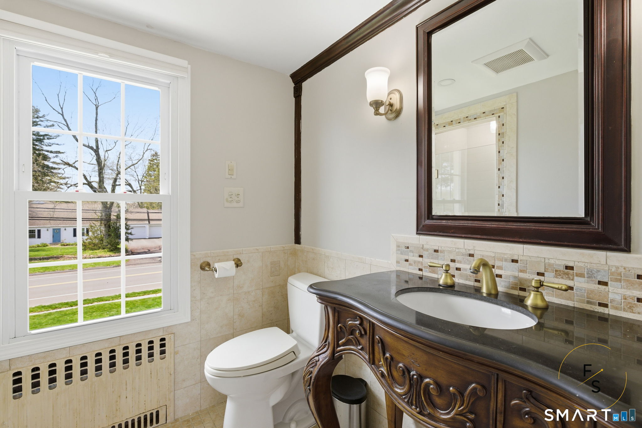 508 Highland Street Wethersfield, CT 06109 - Photo 35 of 40 a bathroom with a granite countertop sink toilet a mirror and a window
