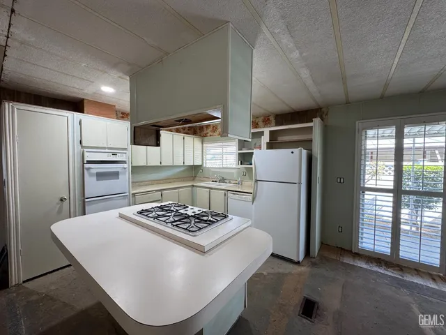a kitchen with refrigerator and stove