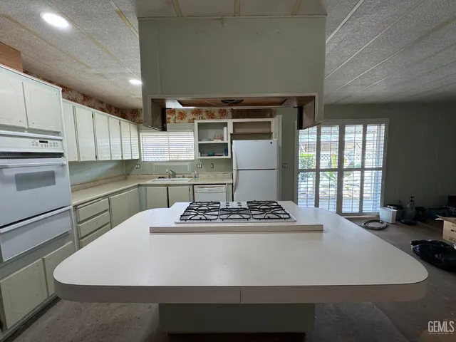a kitchen with a refrigerator and a stove
