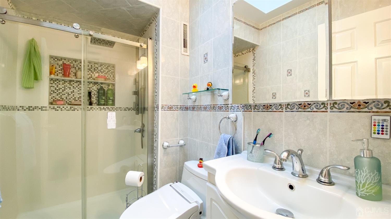 30 Snowflake Lane Edison, NJ 08820 - Photo 14 of 27 a bathroom with a sink a toilet and shower