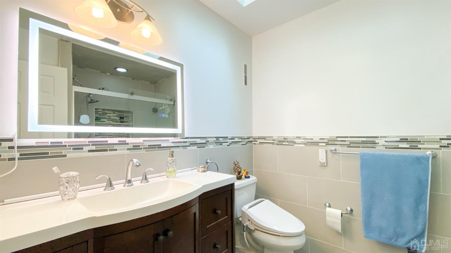 30 Snowflake Lane Edison, NJ 08820 - Photo 19 of 27 a bathroom with a granite countertop sink a toilet and mirror