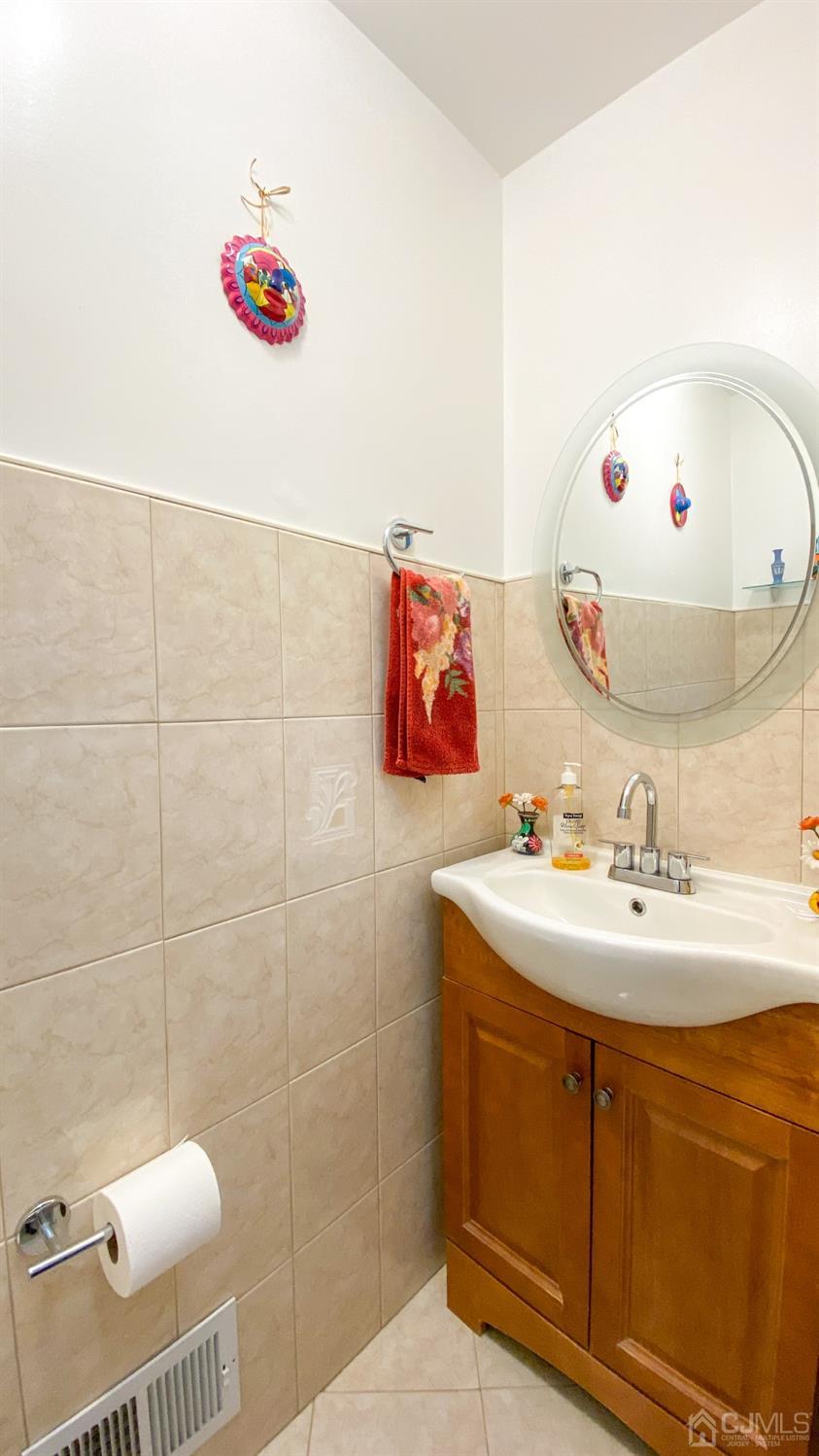 30 Snowflake Lane Edison, NJ 08820 - Photo 7 of 27 a bathroom with a sink mirror and a shower