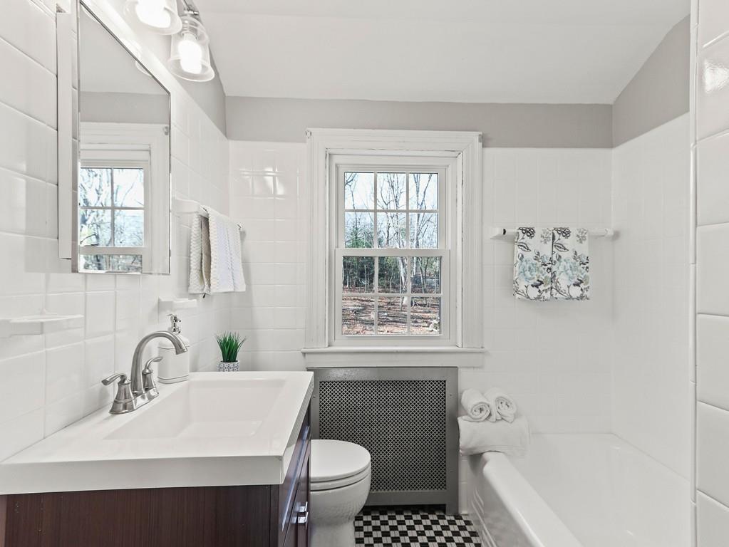 31 Emerson Place Needham, MA 02492 - Photo 16 of 27 a bathroom with a sink toilet and shower