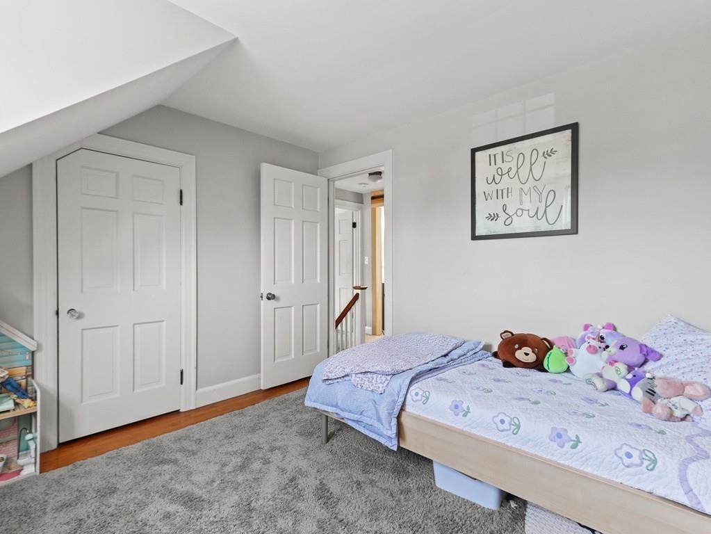 31 Emerson Place Needham, MA 02492 - Photo 17 of 27 a bedroom with a bed and a cabinets