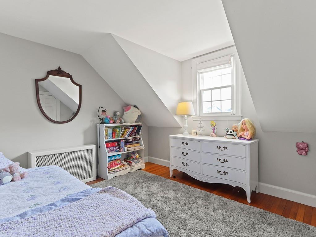 31 Emerson Place Needham, MA 02492 - Photo 18 of 27 a bedroom with a bed closet and a window