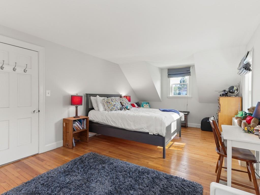 31 Emerson Place Needham, MA 02492 - Photo 19 of 27 a bedroom with a bed and wooden floor