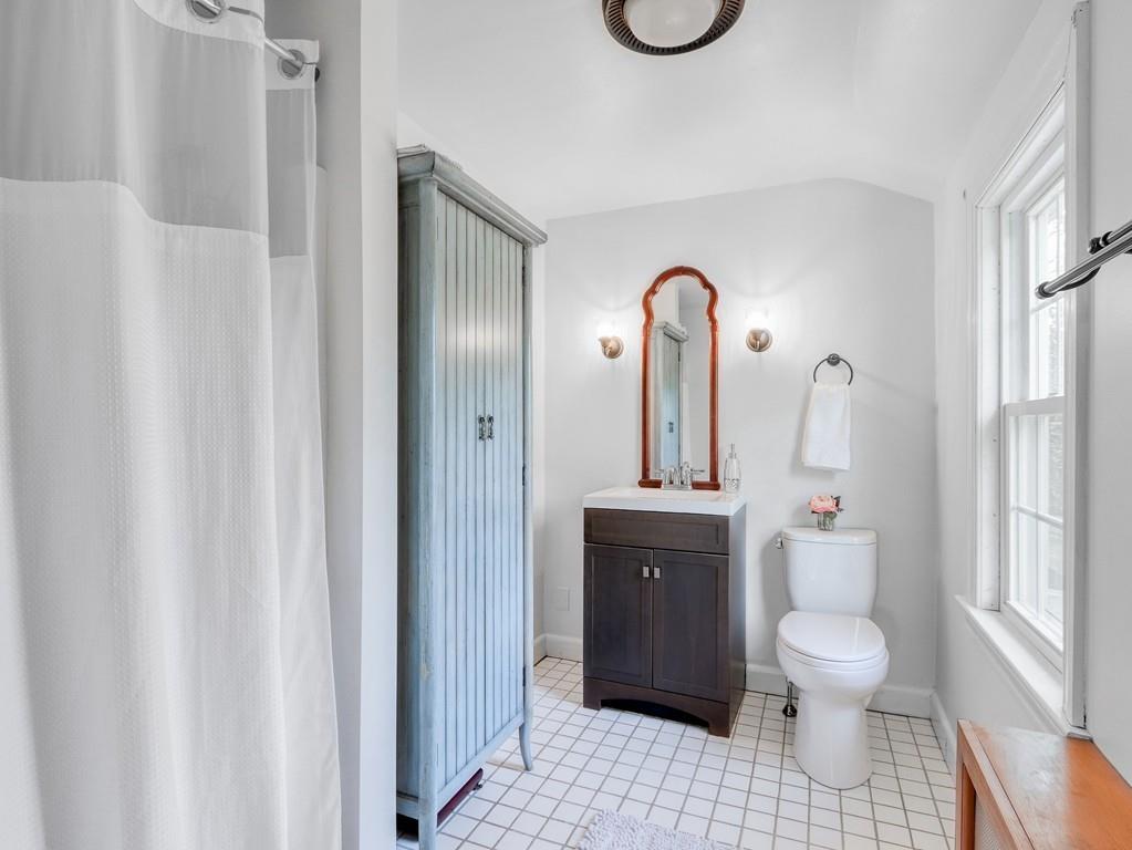 31 Emerson Place Needham, MA 02492 - Photo 24 of 27 a bathroom with a toilet sink a mirror and shower