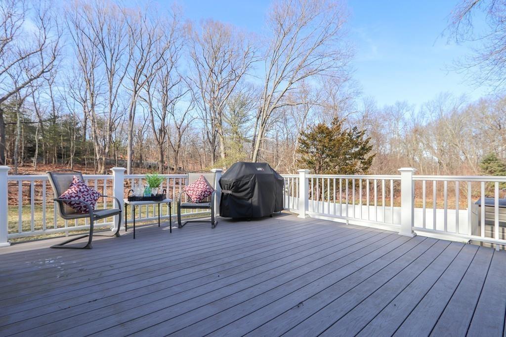 31 Emerson Place Needham, MA 02492 - Photo 25 of 27 a view of a deck with table and chairs a barbeque with wooden floor and fence