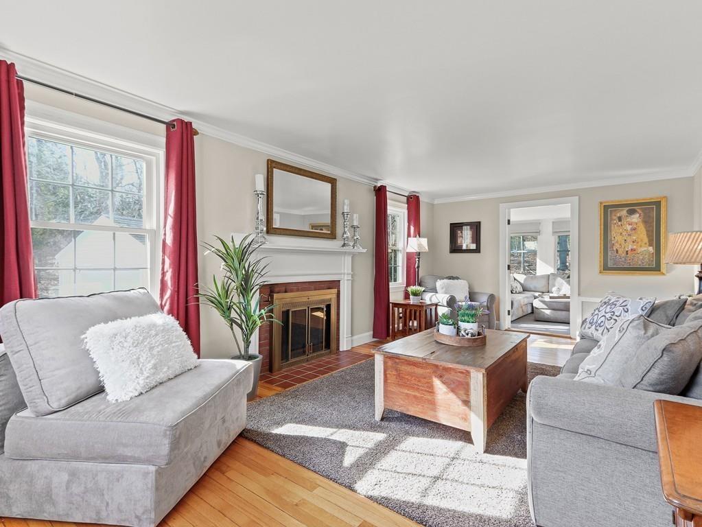 31 Emerson Place Needham, MA 02492 - Photo 3 of 27 a living room with furniture a rug and a fireplace