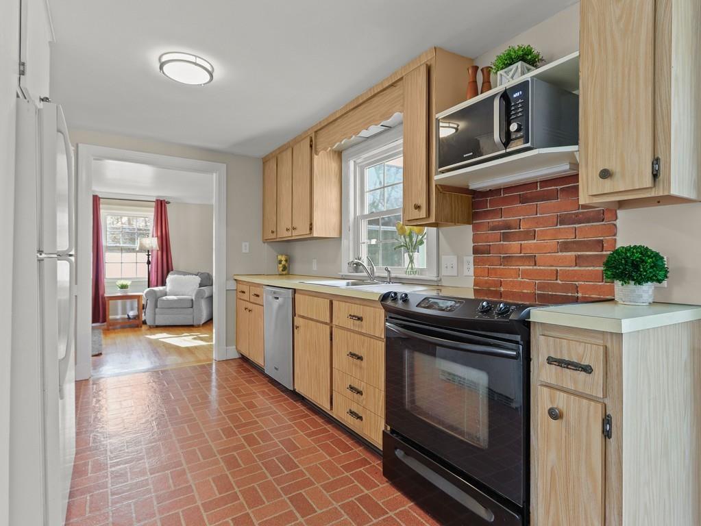 31 Emerson Place Needham, MA 02492 - Photo 8 of 27 a kitchen with a stove top oven and sink