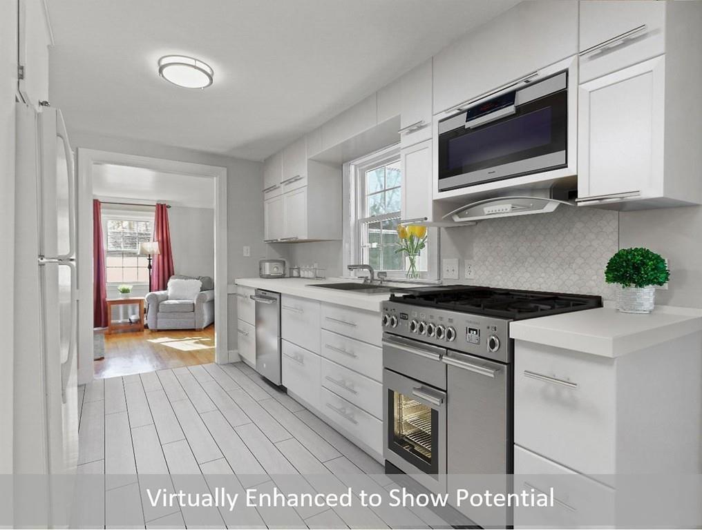 31 Emerson Place Needham, MA 02492 - Photo 9 of 27 a kitchen with a stove a sink and a microwave