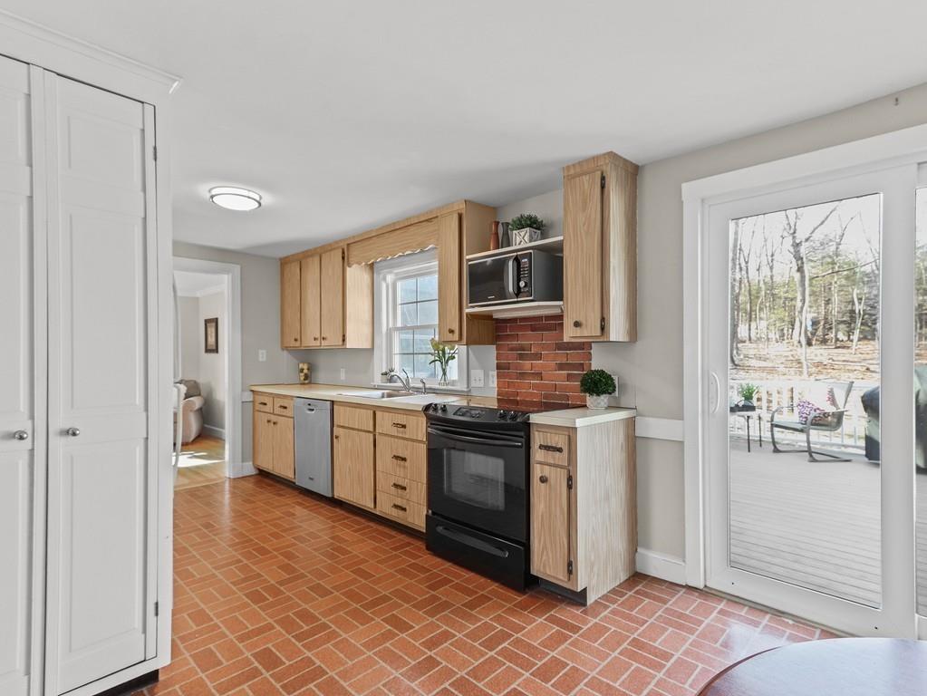 31 Emerson Place Needham, MA 02492 - Photo 10 of 27 a kitchen with stainless steel appliances granite countertop a stove a sink and a refrigerator