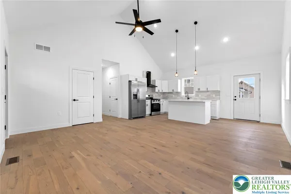 a view of a kitchen with a sink and a refrigerator