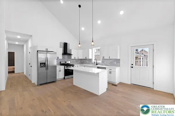 a kitchen with a refrigerator and a sink