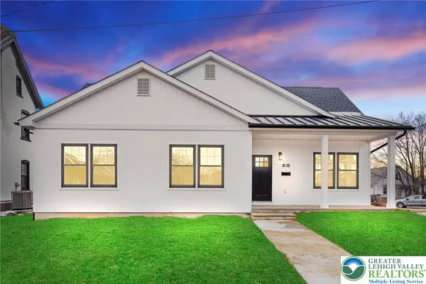 a front view of a house with a yard