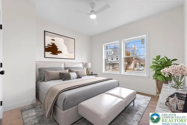 a bedroom with a bed and a painting on the wall
