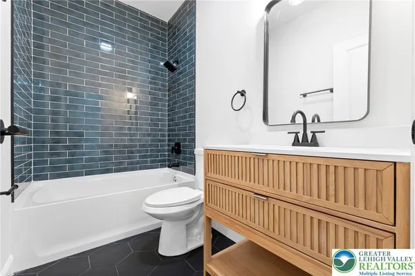 a bathroom with a toilet and a bathtub