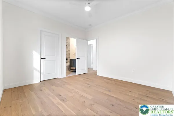 a view of empty room with wooden floor