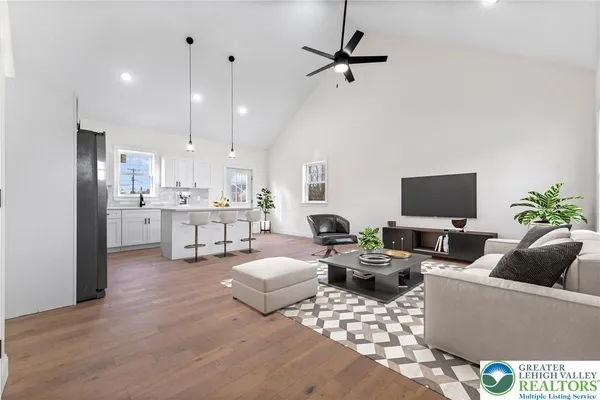 a living room with furniture kitchen view and a window
