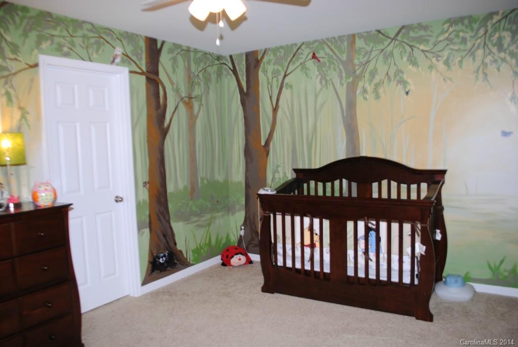 2604 Aldergrove Road Matthews, NC 28105 - Photo 13 of 16 a bedroom with a bed and a chandelier