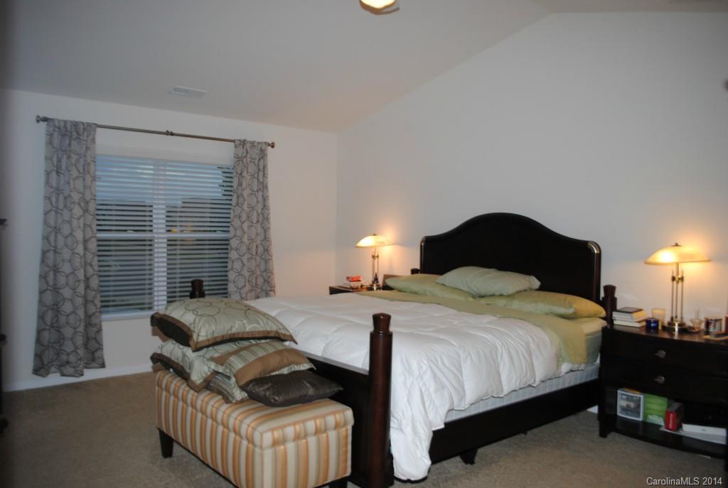 2604 Aldergrove Road Matthews, NC 28105 - Photo 9 of 16 a bedroom with a bed and a lamp