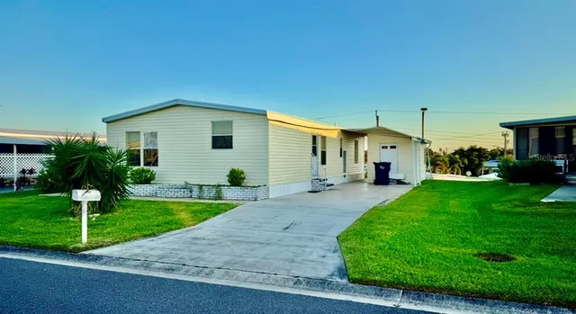 a front view of a house with a yard and porch