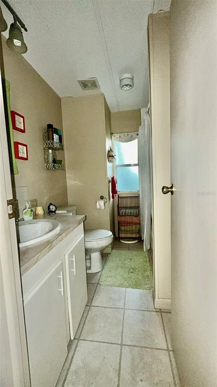 4207 13th Street East Ellenton, FL 34222 - Photo 7 of 15 a bathroom with a sink a toilet and shower