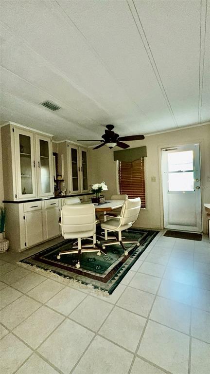 4207 13th Street East Ellenton, FL 34222 - Photo 8 of 15 a living room with a table chairs and a refrigerator