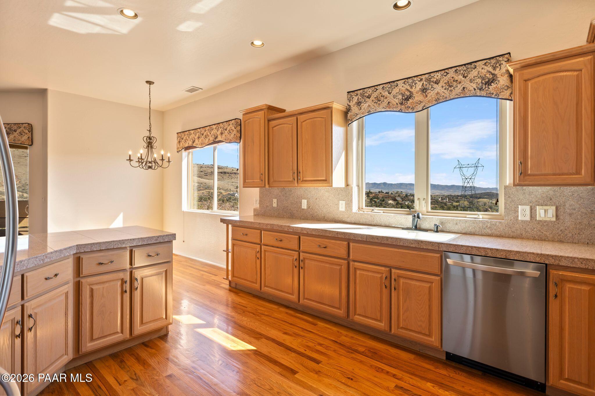 4677 Sharp Shooter Way Prescott, AZ 86301 - Photo 14 of 64 a kitchen with a sink cabinets and wooden floor