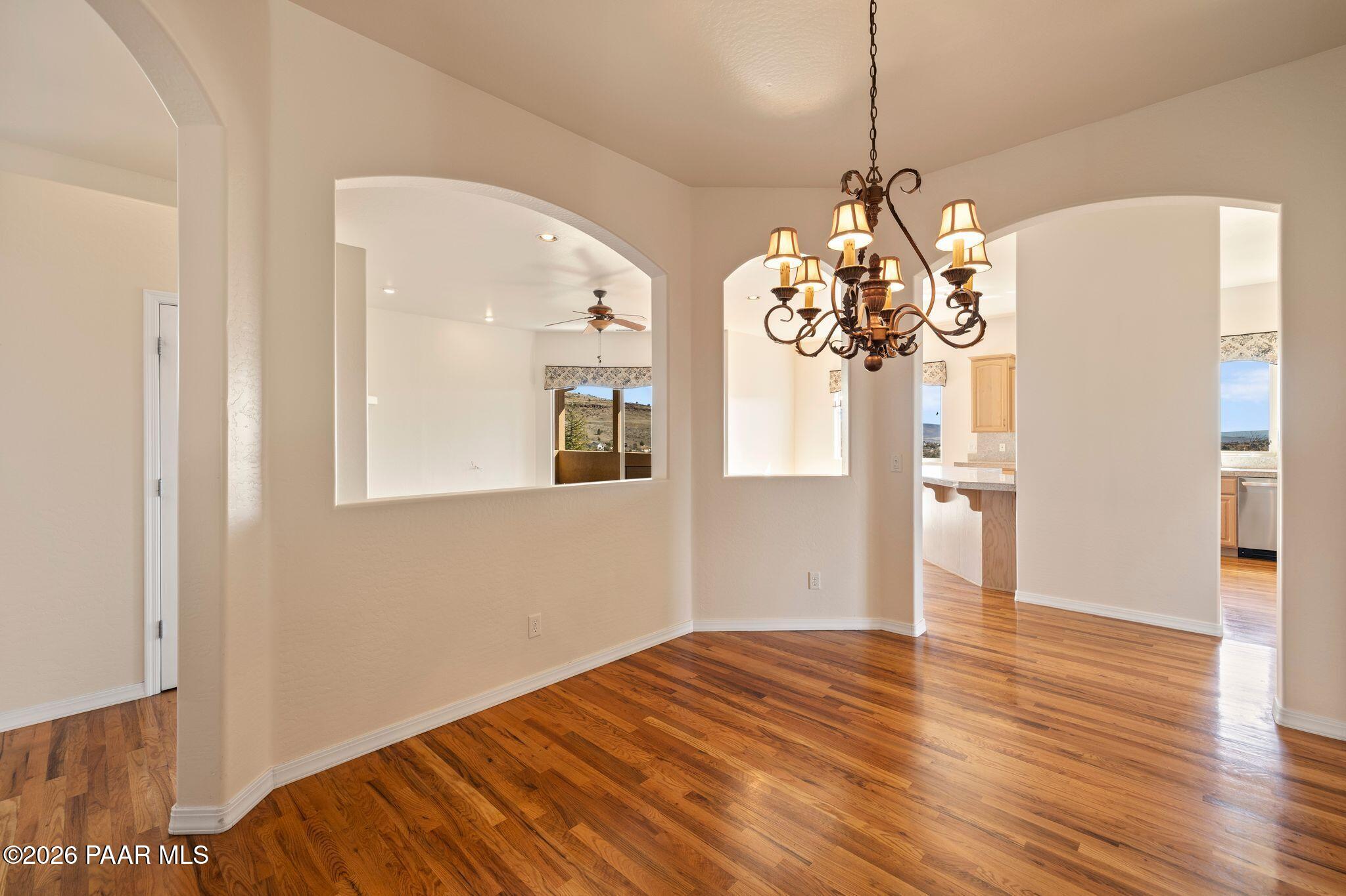 4677 Sharp Shooter Way Prescott, AZ 86301 - Photo 18 of 64 a view of a room with wooden floor and chandelier