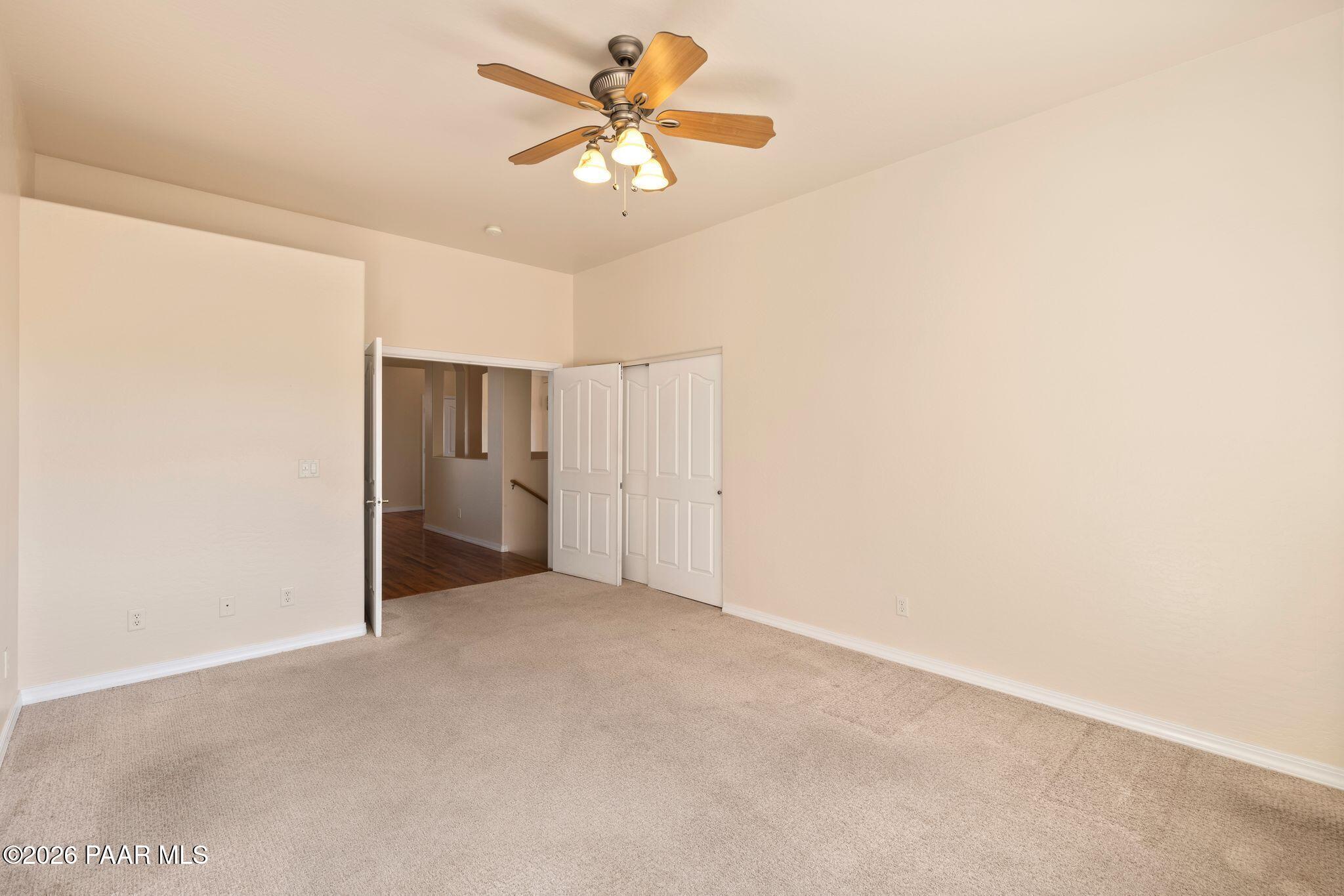 4677 Sharp Shooter Way Prescott, AZ 86301 - Photo 25 of 64 an empty room with a ceiling fan and a window
