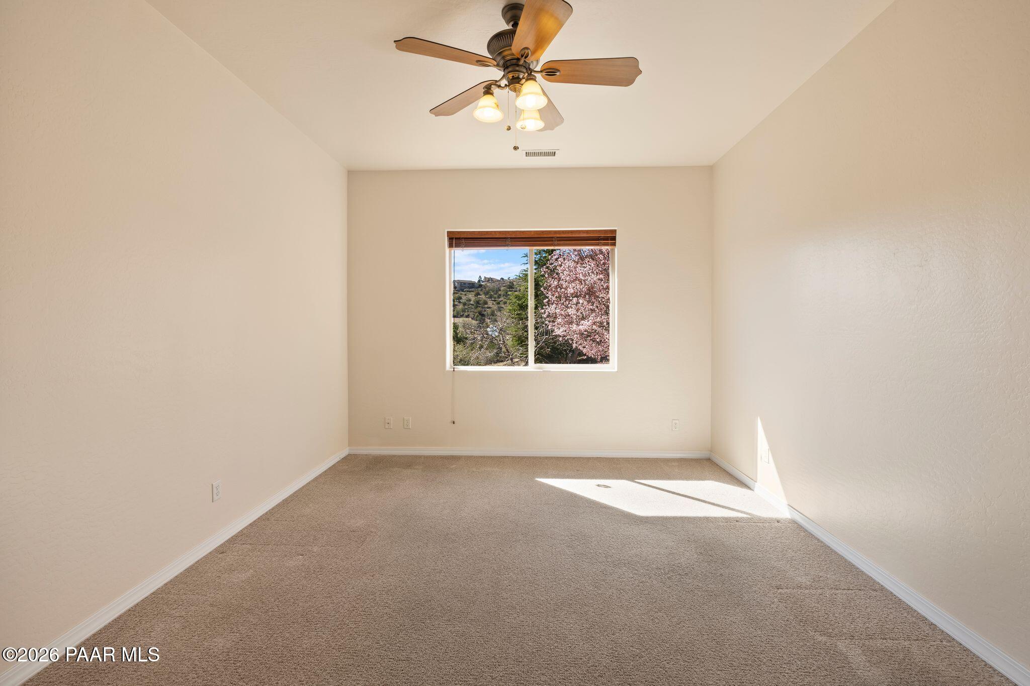 4677 Sharp Shooter Way Prescott, AZ 86301 - Photo 26 of 64 an empty room with a window and a fan
