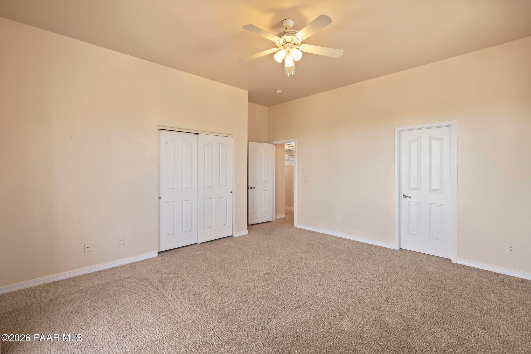4677 Sharp Shooter Way Prescott, AZ 86301 - Photo 28 of 64 an empty room with a ceiling fan and a window