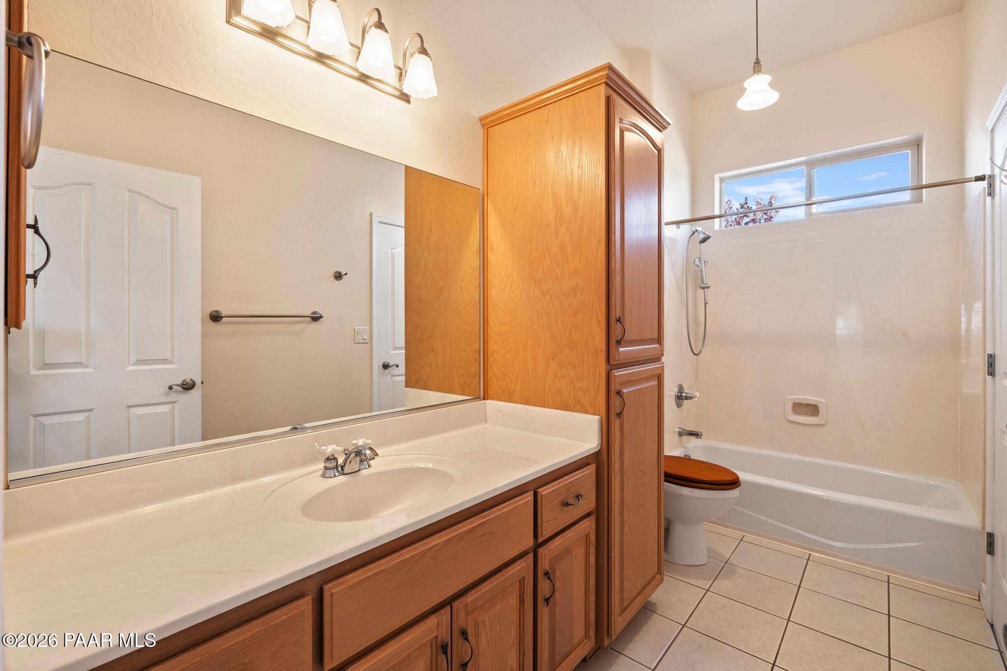 4677 Sharp Shooter Way Prescott, AZ 86301 - Photo 29 of 64 a bathroom with a tub sink shower and a mirror