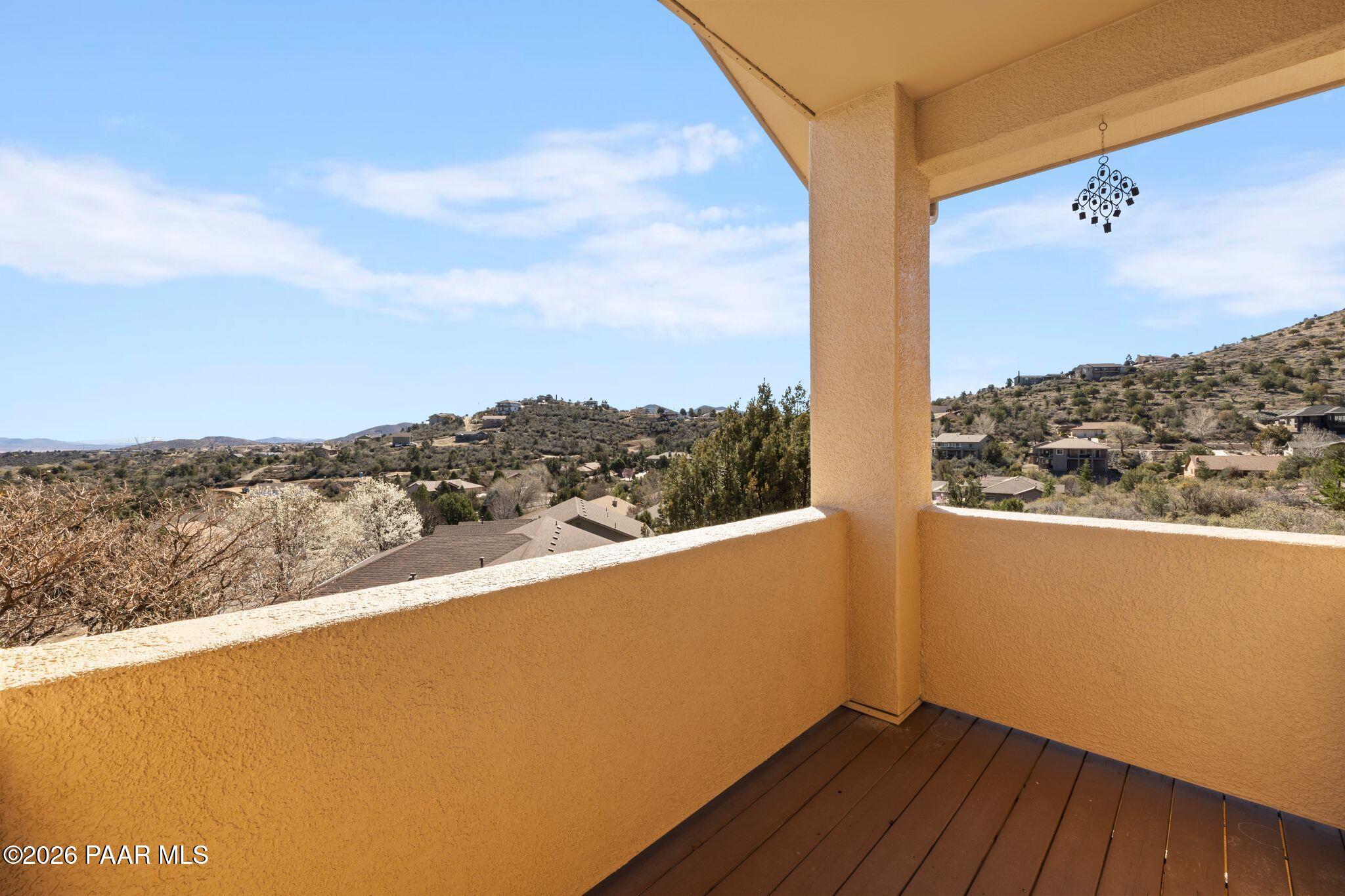 4677 Sharp Shooter Way Prescott, AZ 86301 - Photo 40 of 64 a view of a balcony with wooden floor and a city view